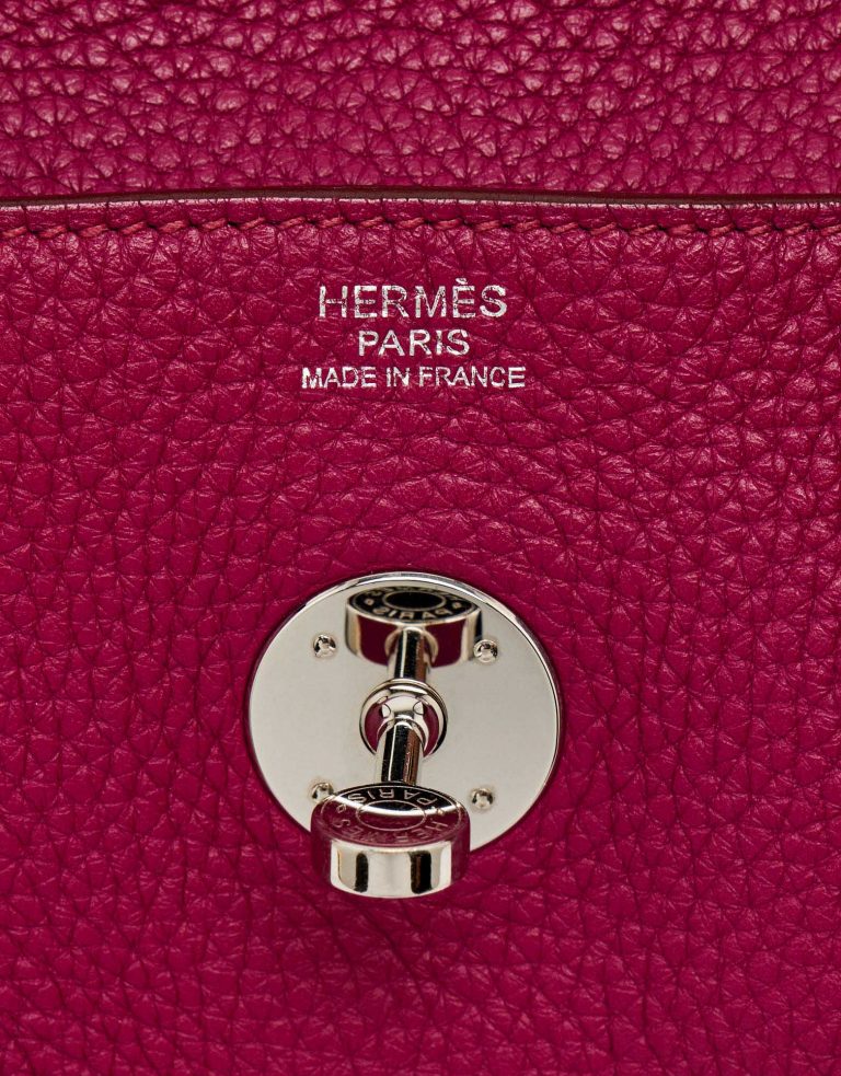 Hardware detail of a pre-loved Hermès Lindy 30 Taurillon Clemence Rubis on SACLÀB