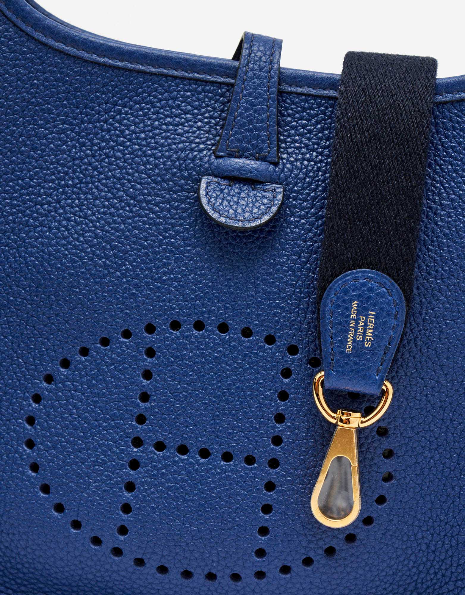 Perforated H on the frontside of a pre-loved Hermès Evelyne 16 Amazone Blue Sapphire / Blue Indigo on SACLÀB