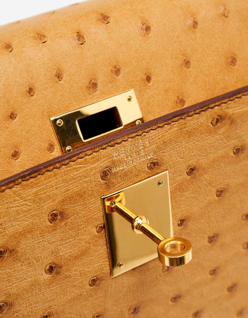 Gold-plated hardware of a pre-loved Hermès Kelly 32 Ostrich Gold on SACLÀB