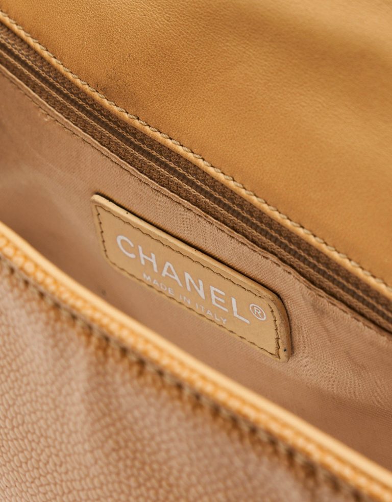 A pre-loved Chanel 2.55 Medium in Beige Caviar Patent Leather on SACLÀB