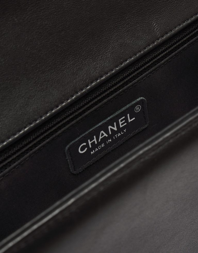 Logo Detail on a pre-loved Chanel Boy Medium Lambskin Black on SACLÀB