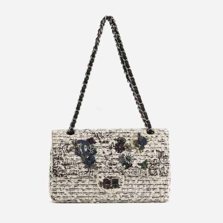 A pre-loved Chanel 2.55 Reissue 226 Tweed White Black Garden Charms on SACLÀB