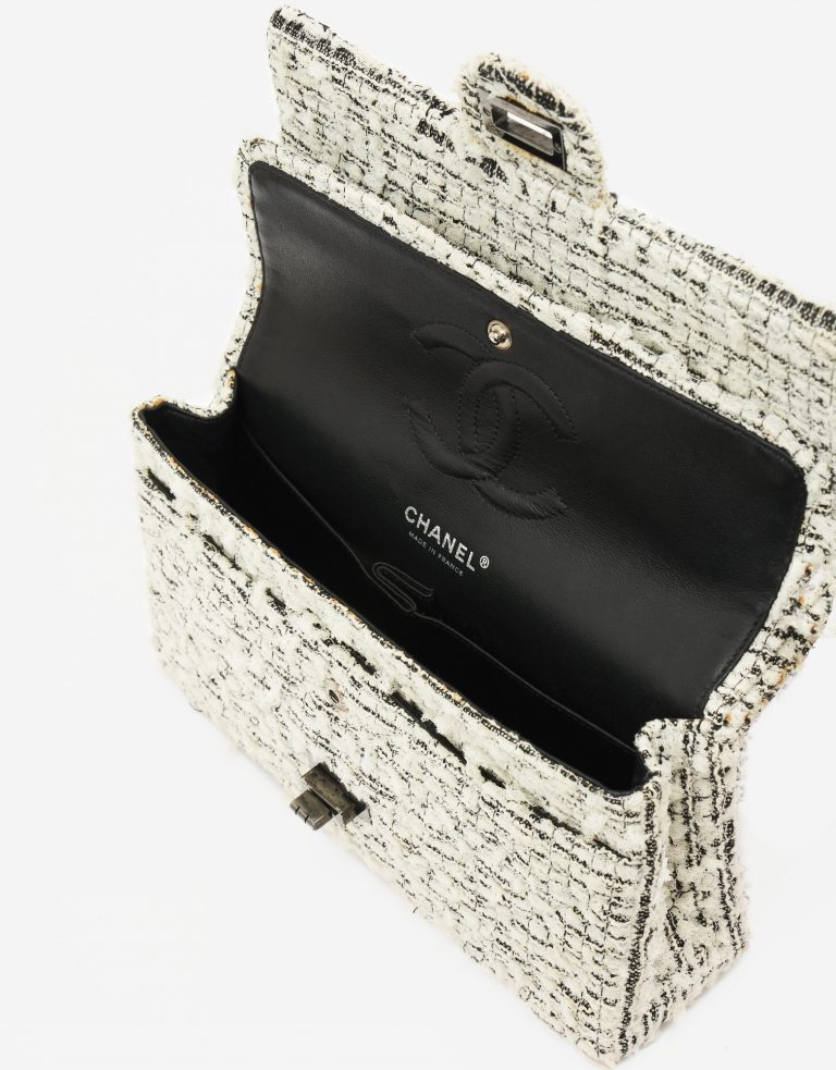 A pre-loved Chanel 2.55 Reissue 226 Tweed White Black Garden Charms on SACLÀB