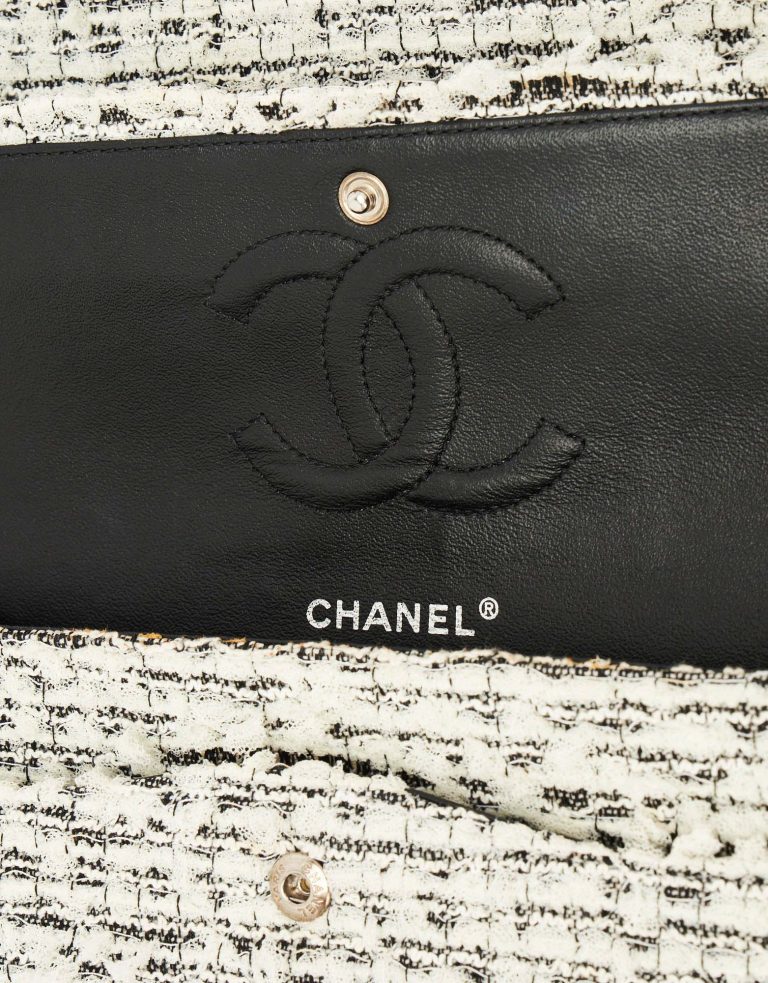 A pre-loved Chanel 2.55 Reissue 226 Tweed White Black Garden Charms on SACLÀB