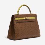 Pre-owned Hermès bag Kelly 32 Ostrich Marron / Vert Anis Brown, Green Side Front | Sell your designer bag on Saclab.com