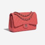 Pre-owned Chanel bag Timeless Jumbo Caviar Coral Pink Side Front | Sell your designer bag on Saclab.com