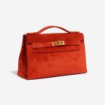 Pre-owned Hermès bag Kelly Pochette Doblis Suede Rouge Vif Red Side Front | Sell your designer bag on Saclab.com