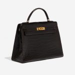 Pre-owned Hermès bag Kelly 32 Porosus Crocodile Dark Brown Brown Side Front | Sell your designer bag on Saclab.com