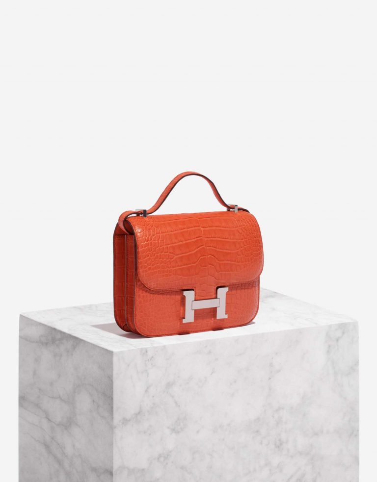 Pre-owned Hermès bag Constance 18 Matte Alligator Orange Poppy Orange Side Front | Sell your designer bag on Saclab.com
