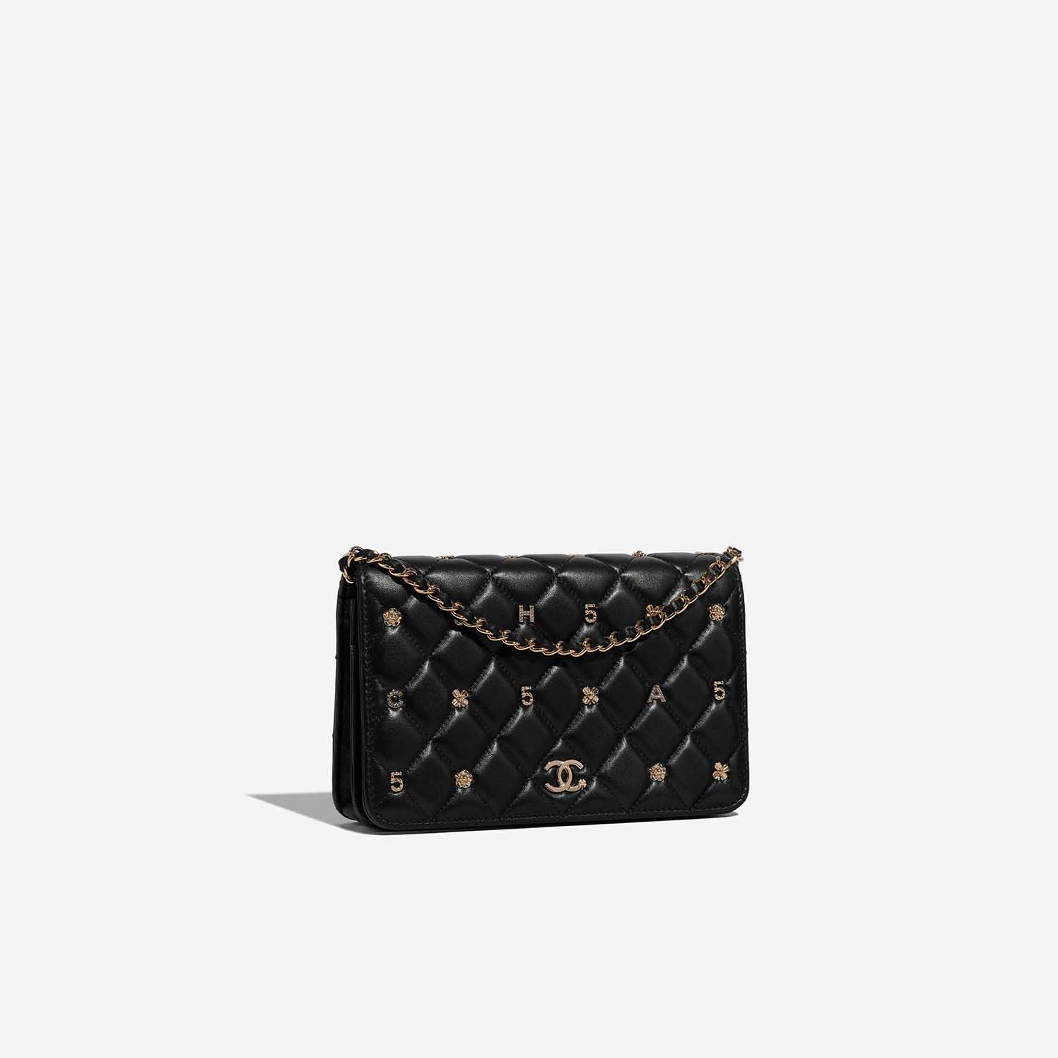 Pre-owned Chanel bag Timeless WOC Lamb Black Lucky Charms Black Side Front | Sell your designer bag on Saclab.com