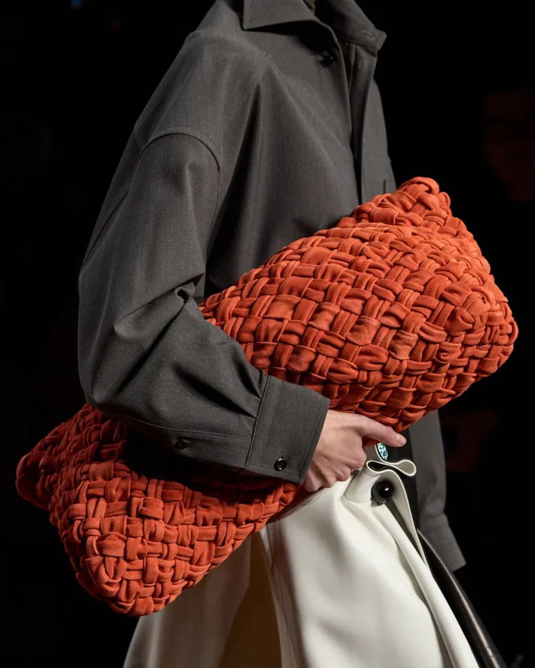 Fall/Winter 2024 Large Red Cylinder-shaped Bottega Veneta Clutch. Image: Launchmetrics Spotlight