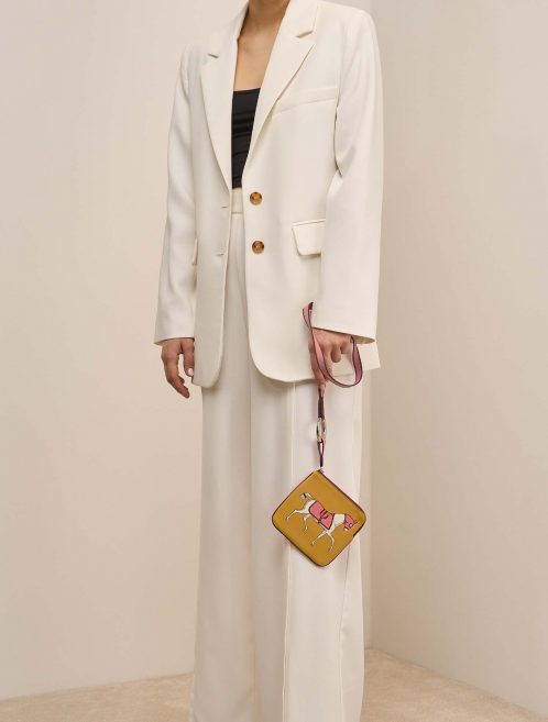 Hermès TrousseCarrePocket OneSize Curry-RoseAzalée-RougeSellier on Model | Sell your designer bag on Saclab.com