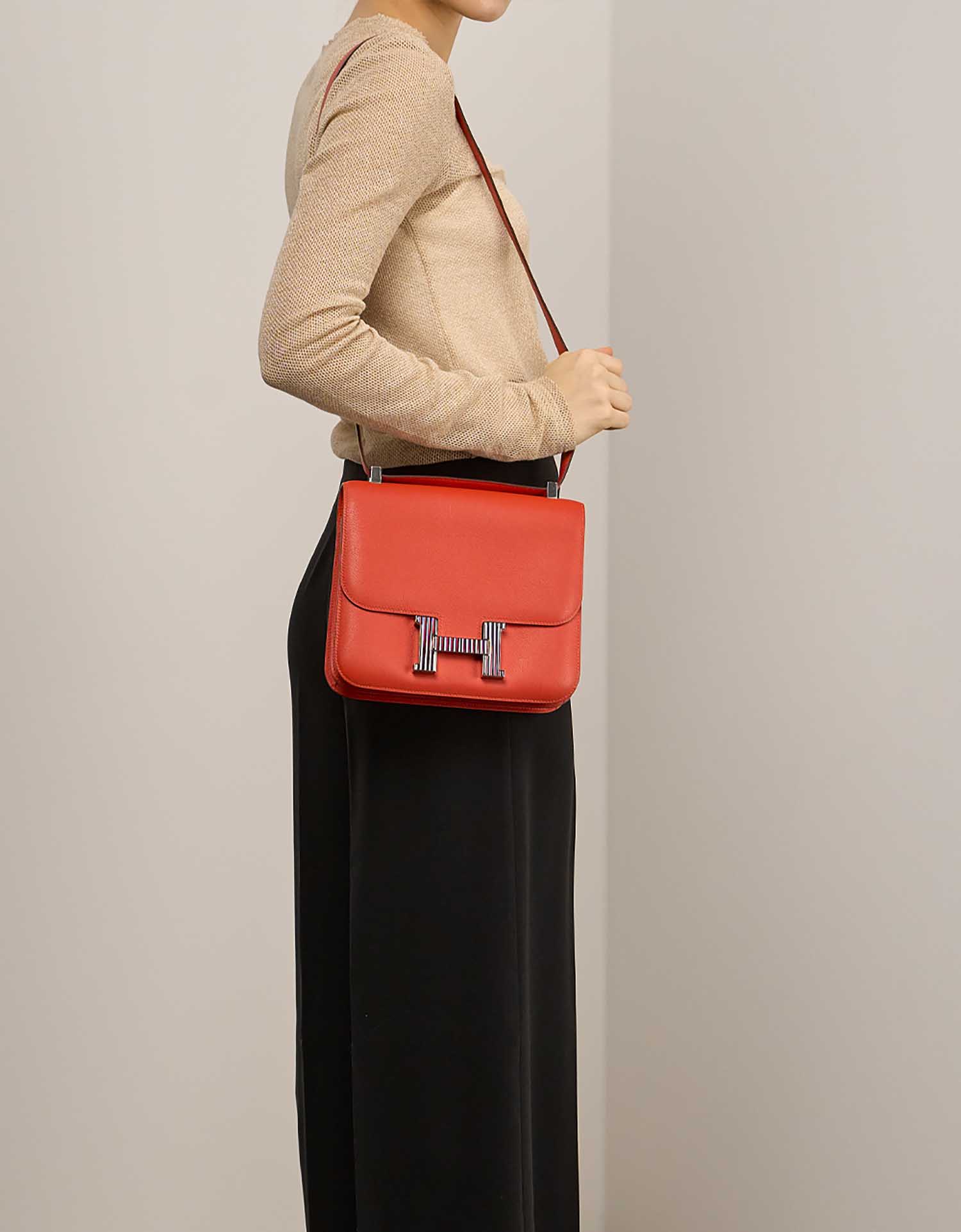Hermès Constance 24 OrangePoppy on Model | Sell your designer bag on Saclab.com