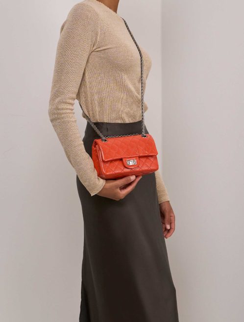 Chanel 2.55 Reissue 224 Patent Orange on Model | Sell your designer bag