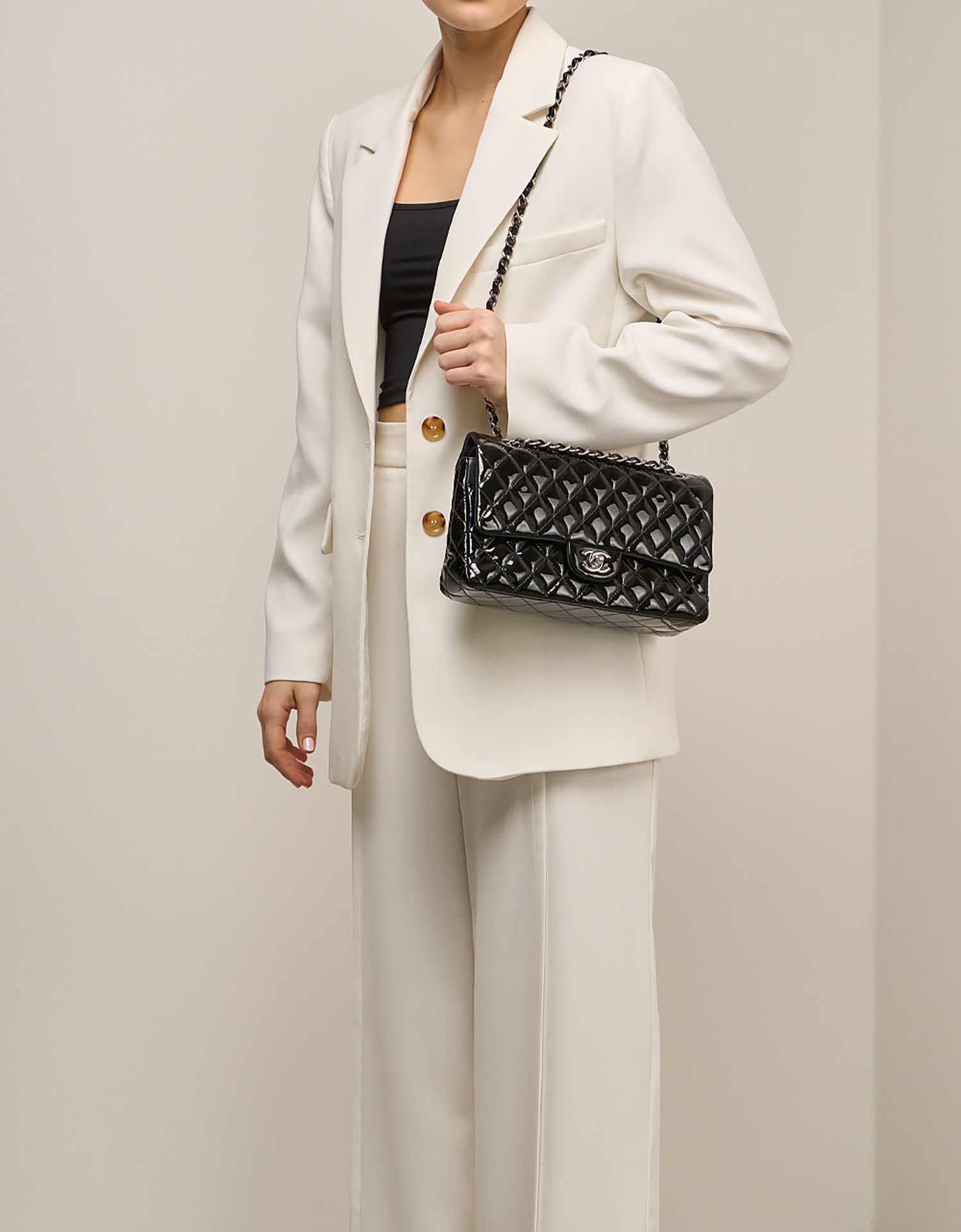 Chanel Timeless Medium Patent Black on Model | Sell your designer bag