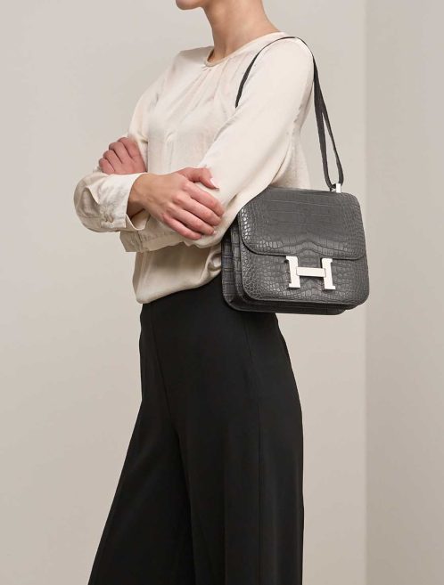 Hermès Constance 24 Matte Alligator Graphite on Model | Sell your designer bag