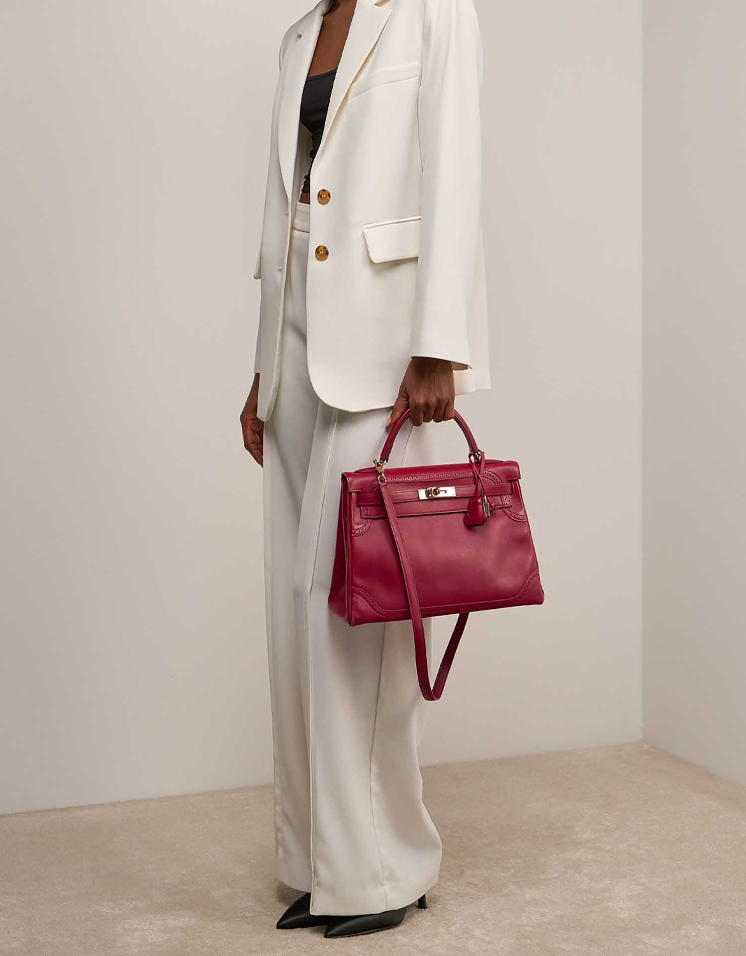 Hermès Kelly 32 Tadelakt Rouge H on Model | Sell your designer bag