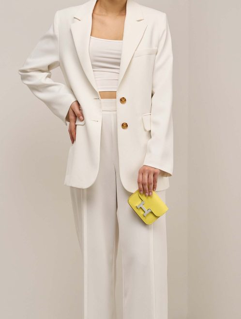 Hermès Constance Slim Wallet Evercolor Lime on Model | Sell your designer bag
