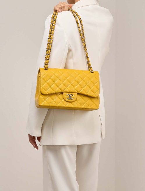 Chanel Timeless Jumbo Caviar Amber on Model | Sell your designer bag