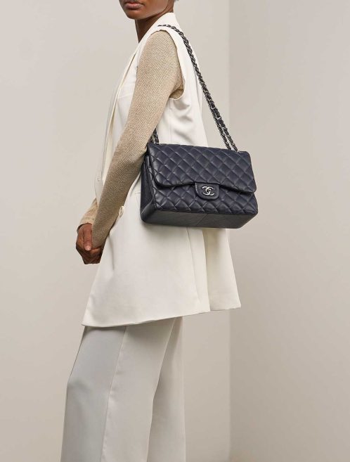 Chanel Timeless Jumbo Lamb Dark Blue on Model | Sell your designer bag